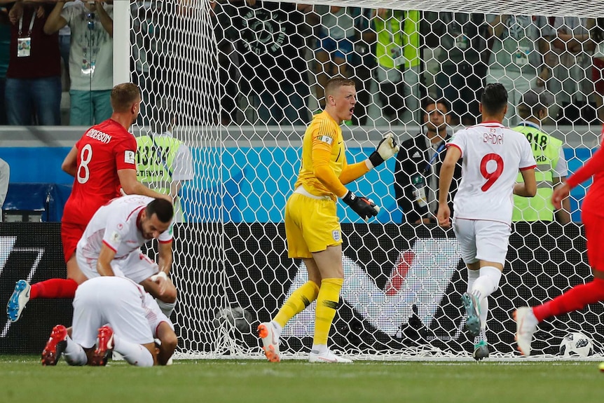 Jordan Pickford rallies the troops after Tunisia scores against England