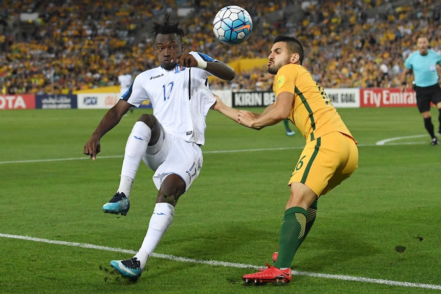 Aziz Behich battles for the ball against Honduras