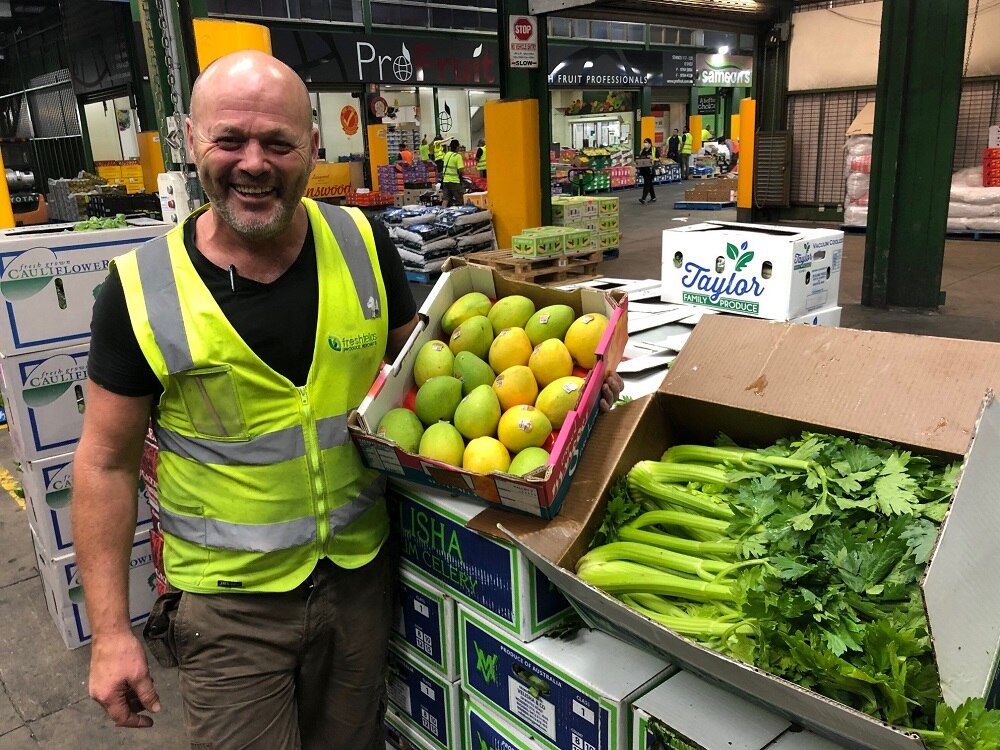 Shaun McInerney displaying boxes of fruit and veg