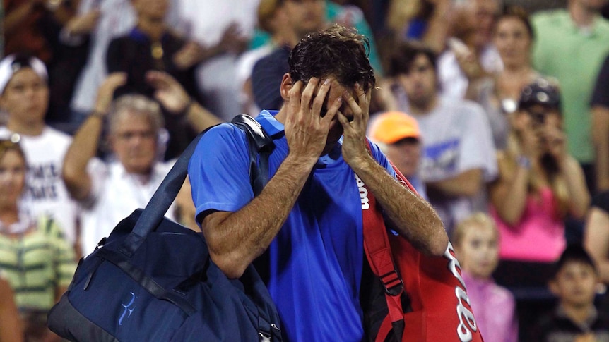 Roger Federer walks off court after losing to Tommy Robredo at the US Open.