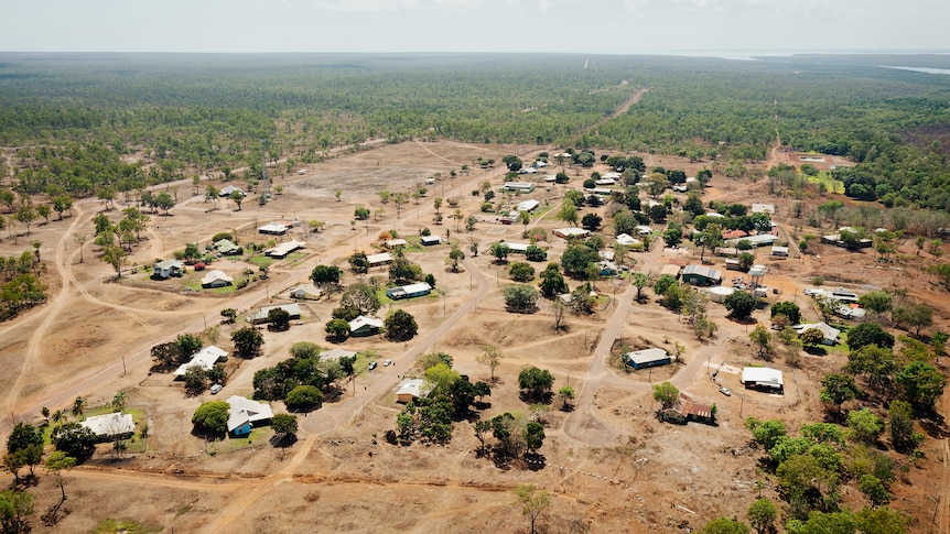 aerial shot of remote houses and bushland