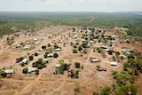aerial shot of remote houses and bushland