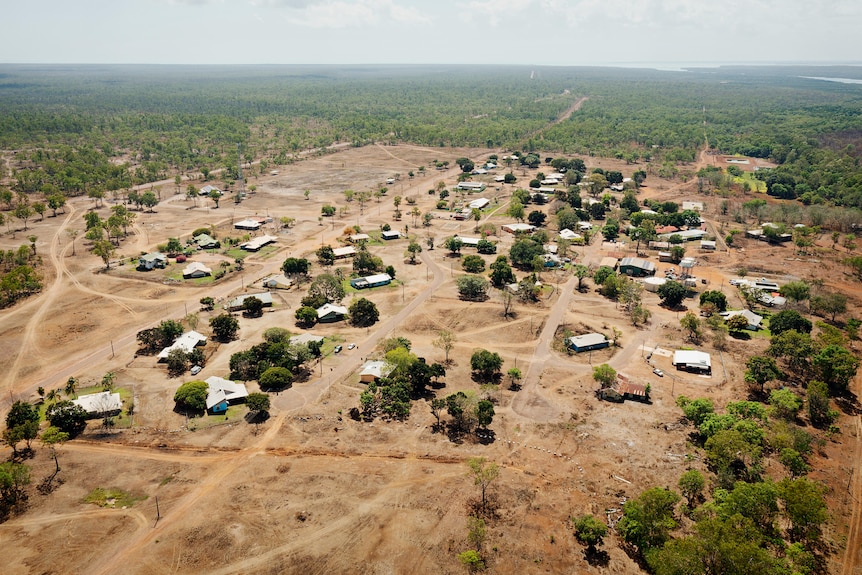 aerial shot of remote houses and bushland