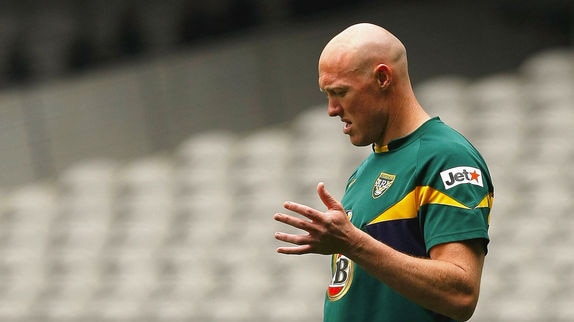 Craig Fitzgibbon kicks the ball at training