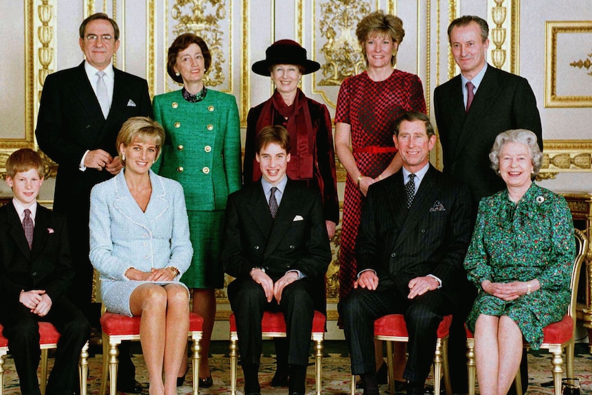 Princess Diana sits between her sons with a woman in a green suit behind them