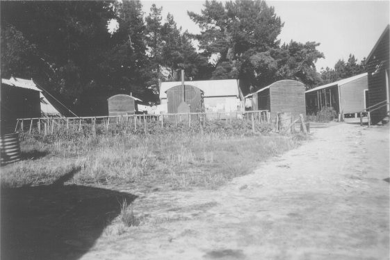 Black and white photo of small shed-like buildings.