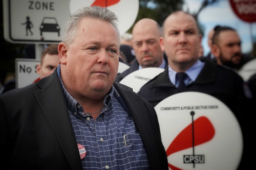 Tom Lynch with prison guards.