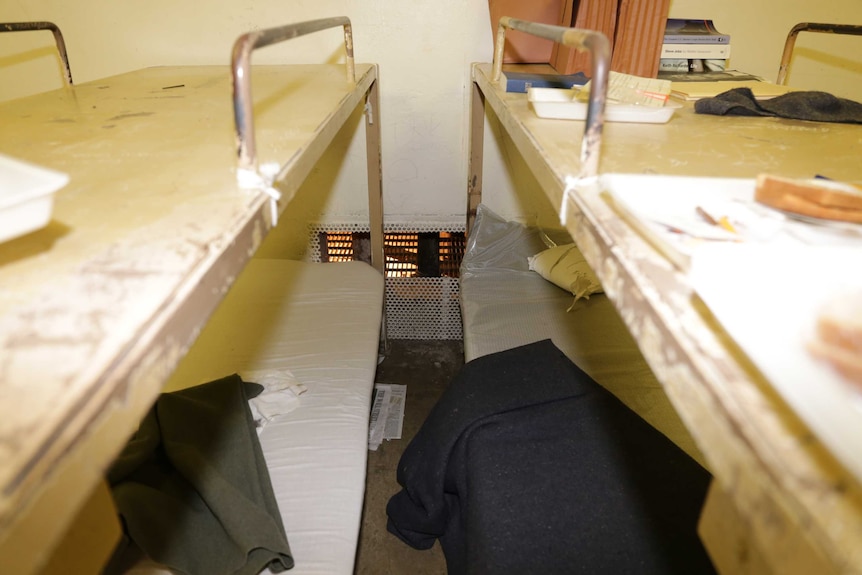 Cell interior shows grill cut for prison escape