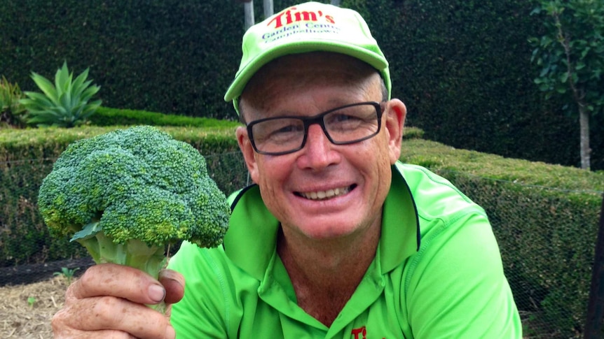 A man hold a head of broccoli