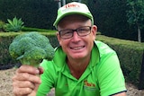 A man hold a head of broccoli