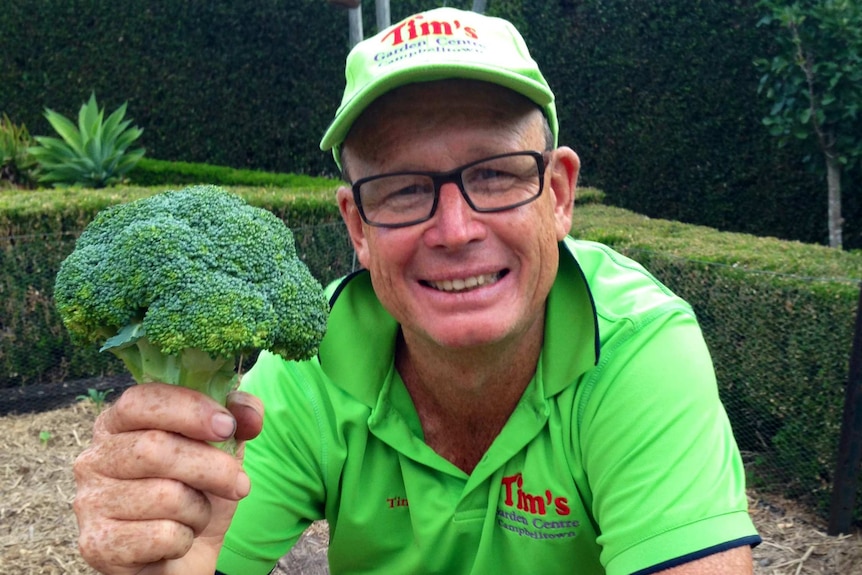 A man hold a head of broccoli