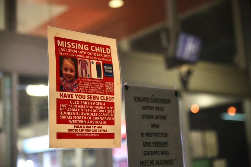 A missing child poster in a shop window