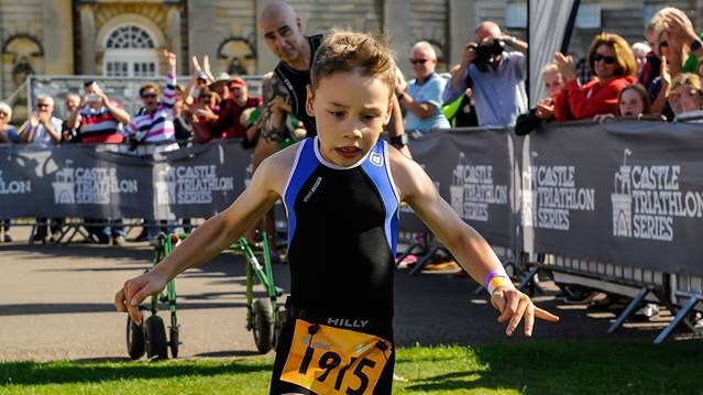 Bailey Matthews, 8, crosses the finish line at the Castle Howard Triathlon.