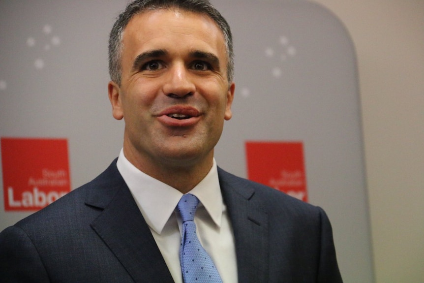 Peter Malinauskas smiles at the camera.