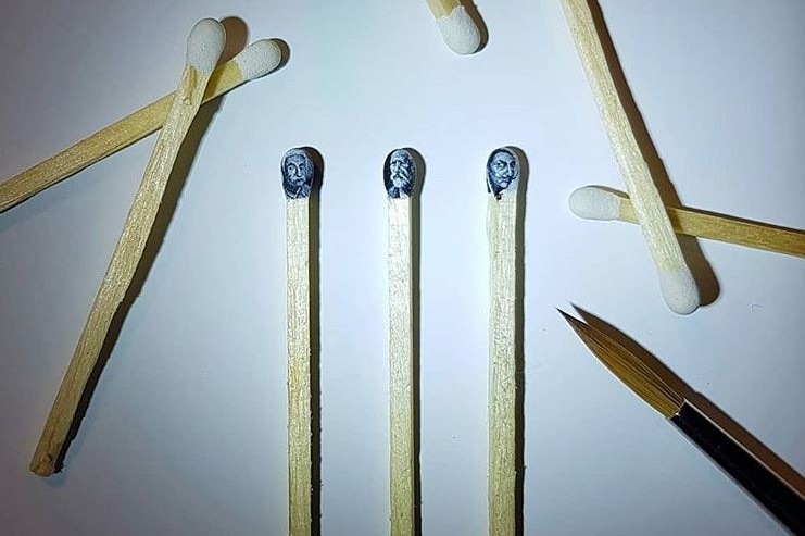 Three matchheads with portraits of Albert Einstein, composer Tchaikovsky and artist Salvador Dali surrounded by other matches