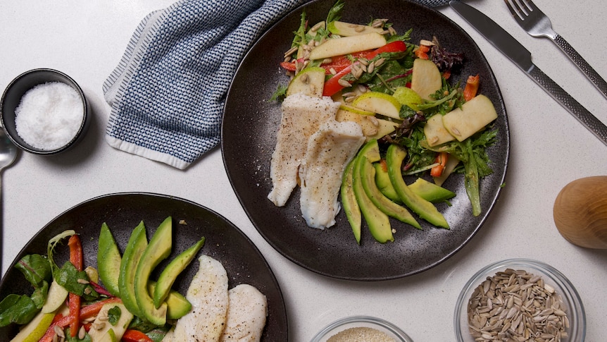 Two servings of steamed fish with a side salad of fruit, capsicum, avocado, a light but hearty dinner.