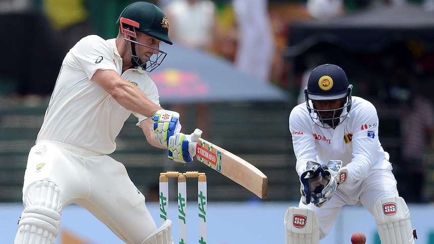 Australia's Shaun Marsh is watched by Sri Lankan wicketkeeper Kusal Perera.