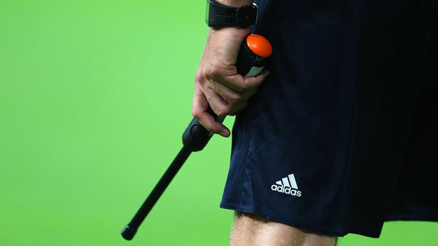 An assistant referee during a UEFA Champions League match between Wolfsburg and CSKA Moskva.
