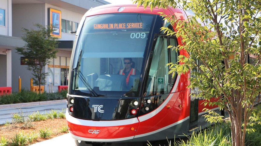 Light rail vehicle and driver pulling in to Gungahlin Place station.