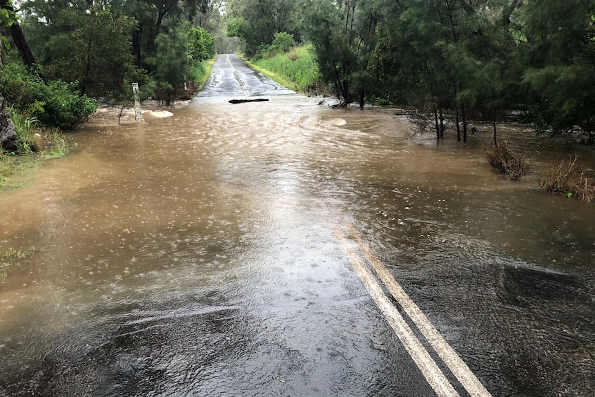 Water flows over a road