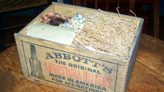 Wooden box with angosture bitters bottles inside