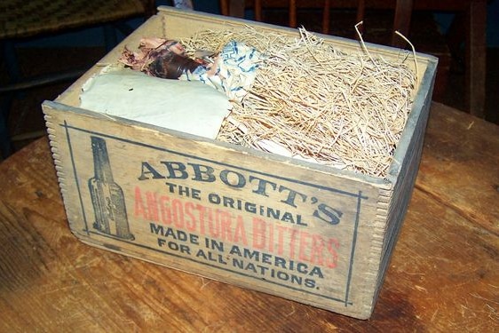 Wooden box with angosture bitters bottles inside