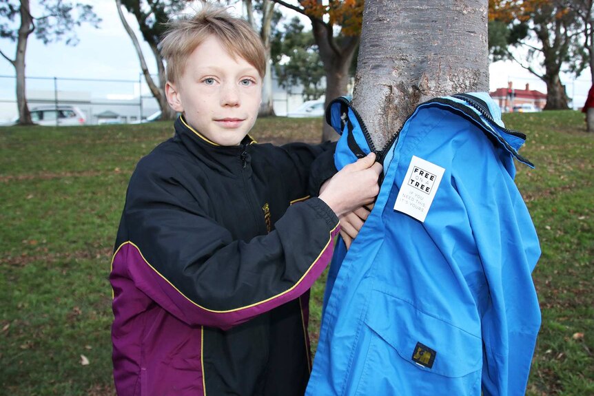 Oliver Edwards with a garment on offer in Hobart as part of the Free On A Tree initiative.