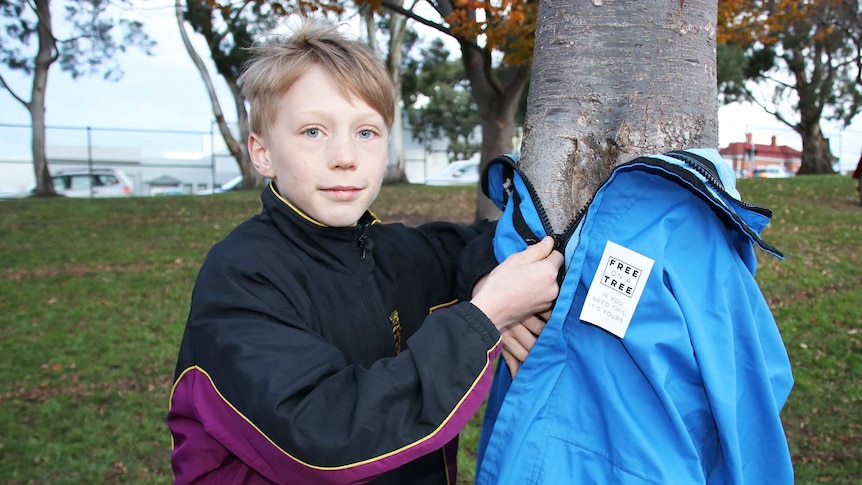 Oliver Edwards with a garment on offer in Hobart as part of the Free On A Tree initiative.