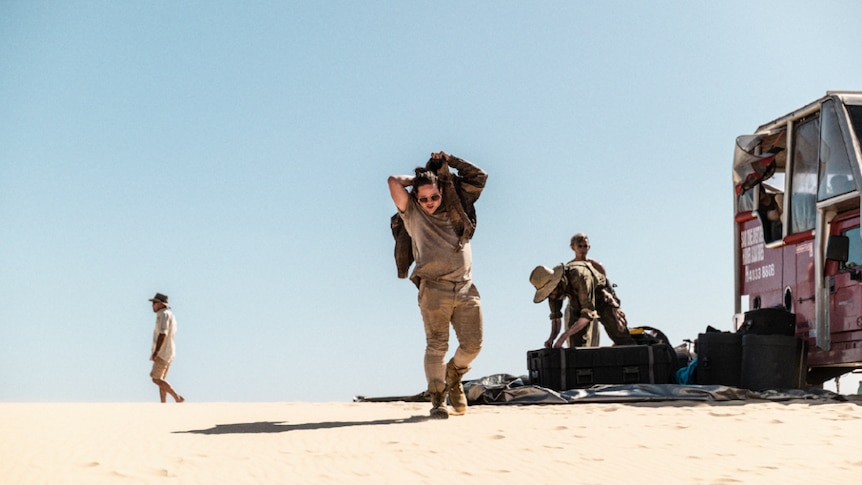 Polaris and crew members in a sand dune