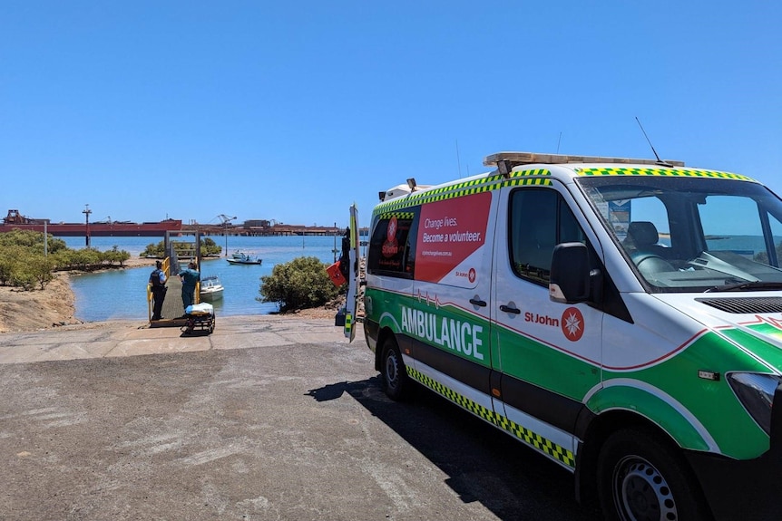 An ambulance parked at a beach.