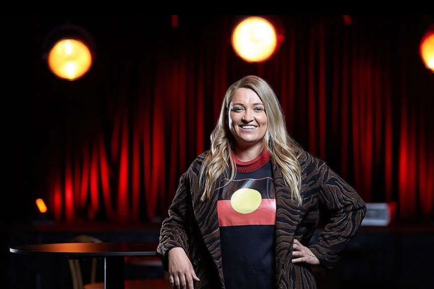 A photo of Alethea Beetson, wearing a t-shirt with an Aboriginal flag