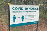 Close-up of COVID-19 social distancing sign at Daisy Hill Conservation Park.