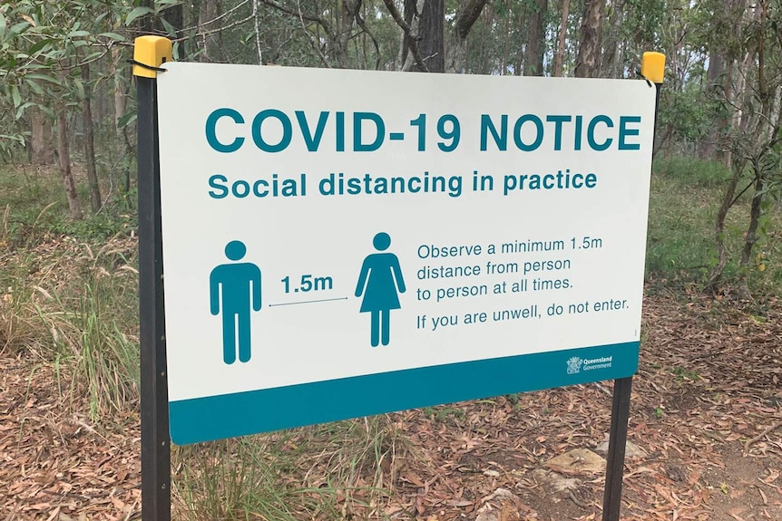 Close-up of COVID-19 social distancing sign at Daisy Hill Conservation Park.