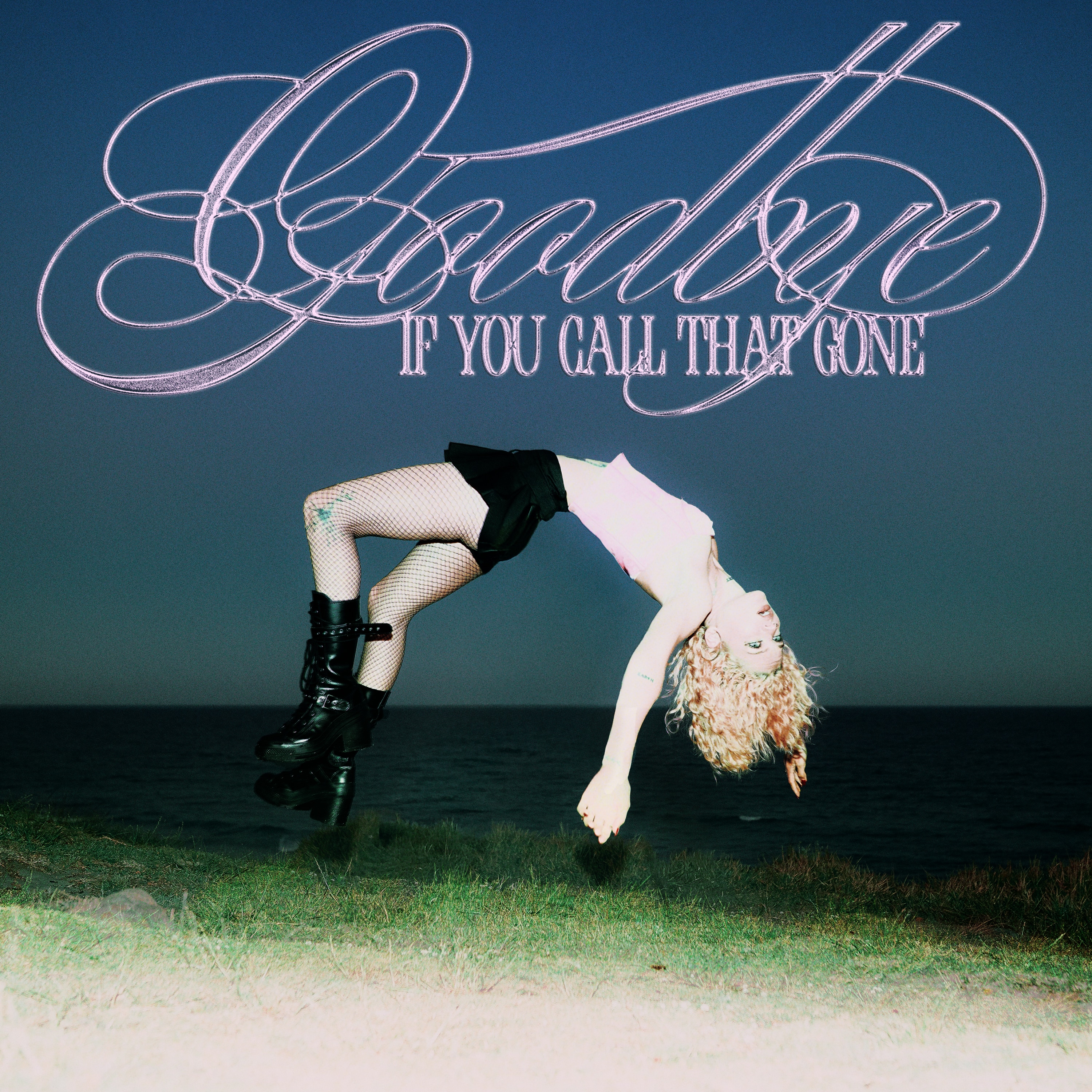 MAY-A floating in the air with grass and sky in the background