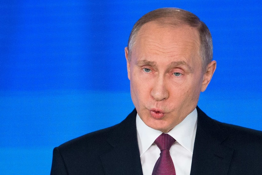 Vladimir Putin pulls a face during his speech