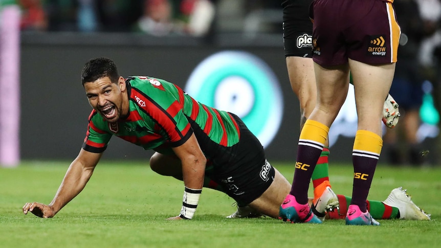 Cody Walker crawls along the ground after scoring a try to pay tribute to Greg Inglis and his goanna celebration.
