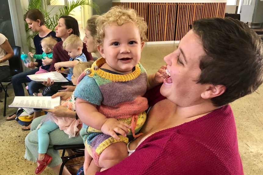 Mum and baby smiling.