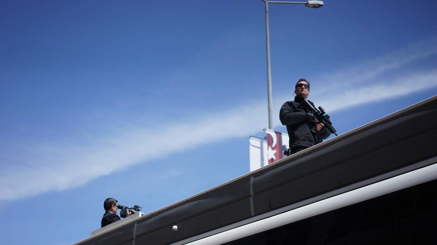 Security personnel with automatic rifles on roof of bus in Gallipoli