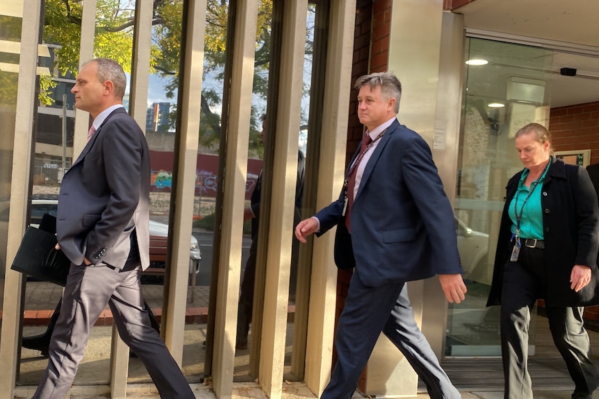 SA Police Major Crime squad members leave the Adelaide Youth Court.