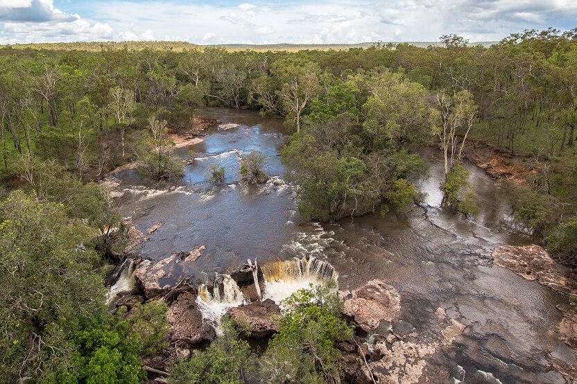 An aerial picture of Wenlock River Falls during wet season, with water running over rocks