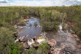 An aerial picture of Wenlock River Falls during wet season, with water running over rocks