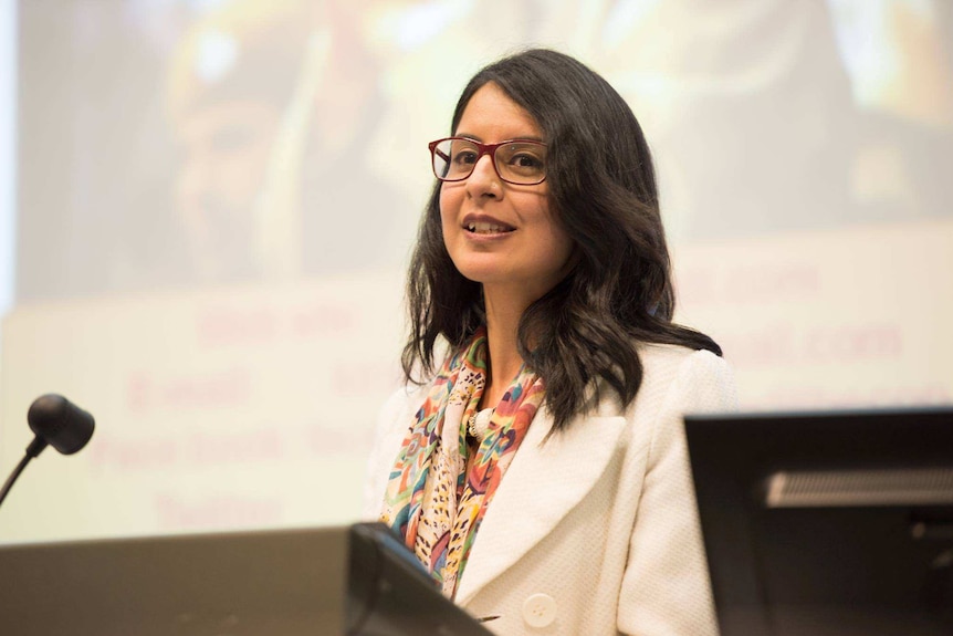 Sukhmani Khorana speaking with microphone