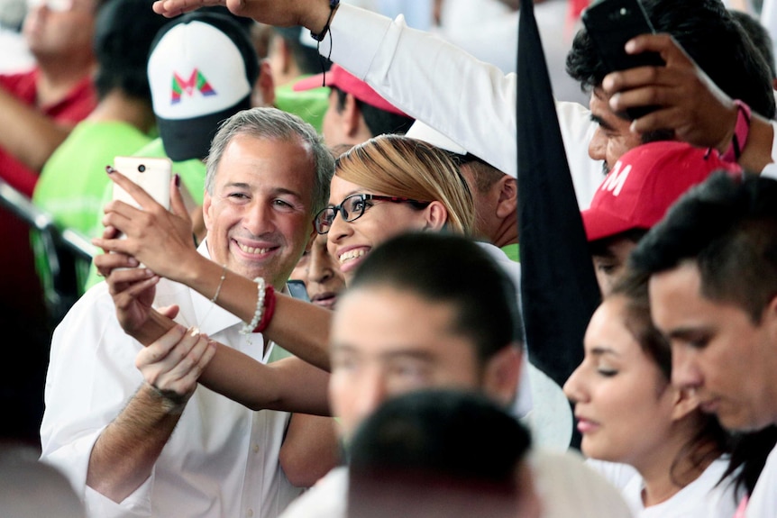 A man poses for a selfie