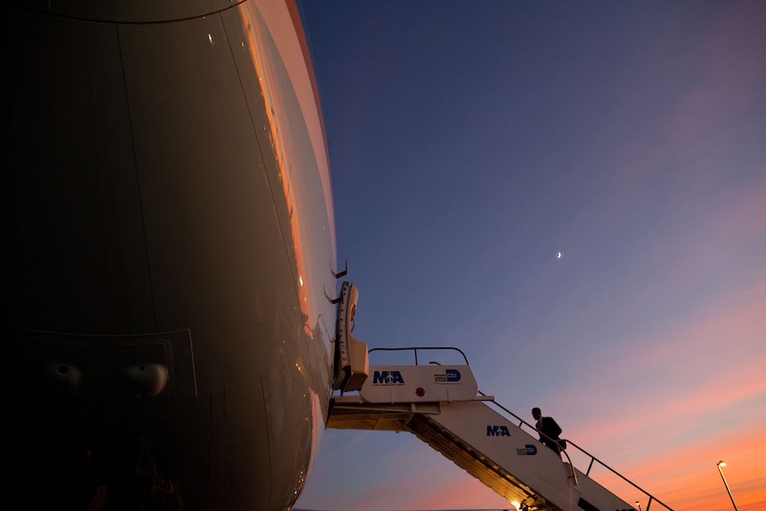 President Barack Obama boards Air Force One