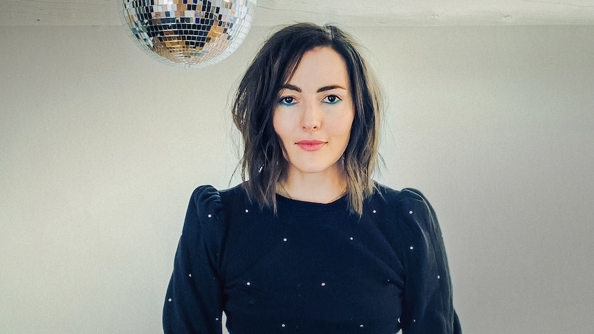 Lizzy Goodman stands below a disco ball