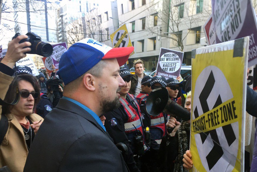 United Patriots Front member Neil Erikson faces off with protesters.