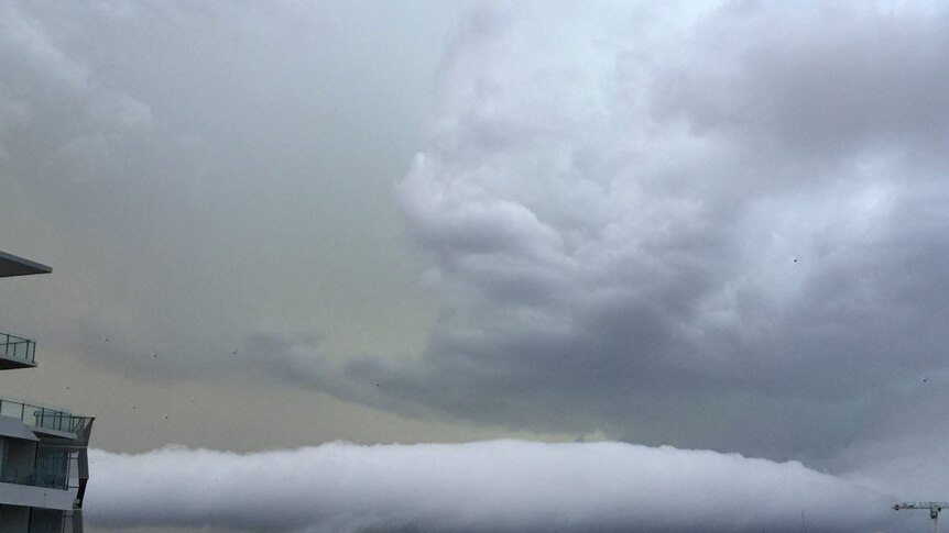 Storm clouds roll in over Brisbane as the city is hit by storm cells