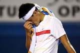 Tired Tomic: The 17-year-old toiled for nearly four hours before losing in five sets.