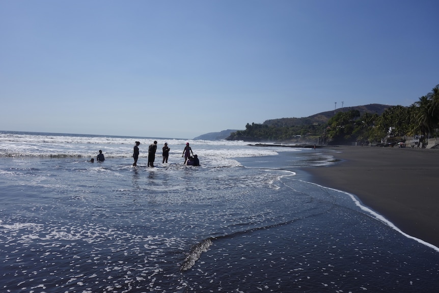 Silhouette of a group of people in the ocean