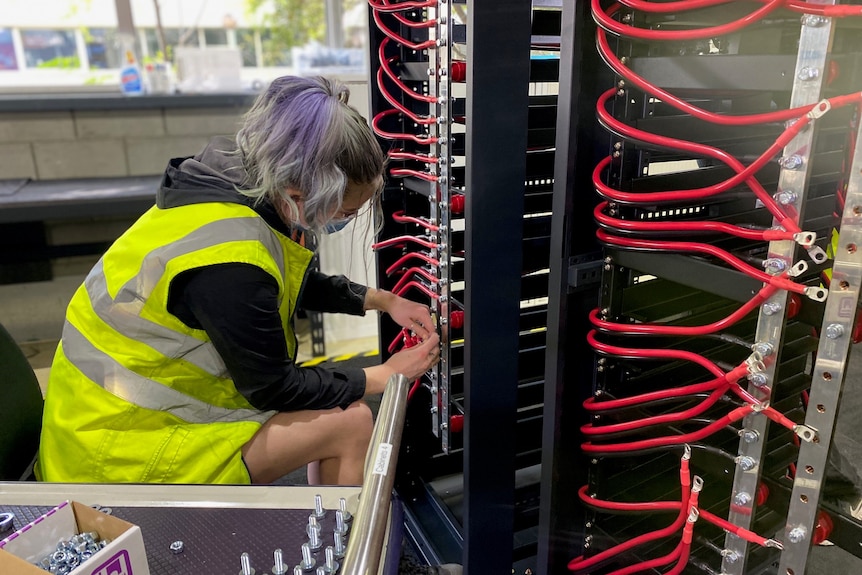 a woman with electrical tools in a factory